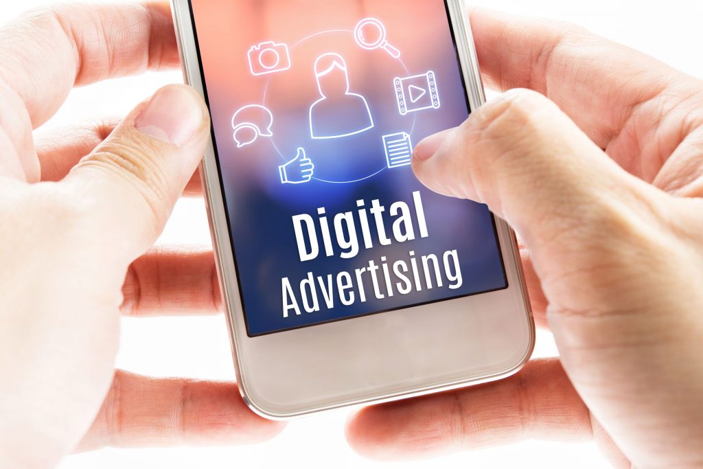 close up hand holding mobile with digital advertising and icons, digital marketing concept.